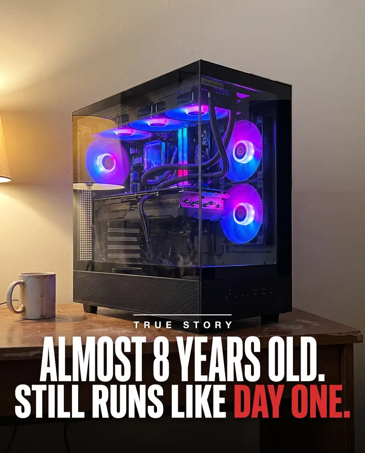 Spec ad for Skytech Gaming styled as a tabloid photo. A black glass gaming PC with glowing purple fans sits on a worn wooden desk next to a coffee mug, under the words True story, almost 8 years old, still runs like day one.